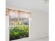 Bedroom with window overlooking lush greenery at 6906 Woodwind Dr # 12, Sarasota, FL 34231