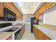 Efficient kitchen with wood cabinets and appliances at 6906 Woodwind Dr # 12, Sarasota, FL 34231
