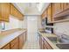 Bright kitchen with wood cabinets and modern appliances at 6906 Woodwind Dr # 12, Sarasota, FL 34231
