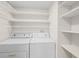 Laundry room with washer, dryer, and shelving at 6906 Woodwind Dr # 12, Sarasota, FL 34231