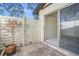 Private patio with wood fence and small potted plant at 6906 Woodwind Dr # 12, Sarasota, FL 34231