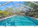Relaxing community pool area with screened enclosure, providing shade and comfort at 6906 Woodwind Dr # 12, Sarasota, FL 34231