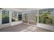 Bright sunroom with multiple windows and view of backyard at 6906 Woodwind Dr # 12, Sarasota, FL 34231