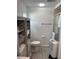 Bathroom with toilet, shower, storage cabinet, and flooring at 782 Londra Dr, Venice, FL 34285