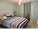 Bedroom with striped bedding, and ample closet space at 782 Londra Dr, Venice, FL 34285