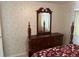 Bedroom with wooden dresser and mirror at 782 Londra Dr, Venice, FL 34285