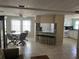 Kitchen and dining area with white cabinets, tile flooring, and breakfast bar at 782 Londra Dr, Venice, FL 34285