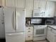 Modern kitchen with white cabinets, granite countertops, and stainless steel appliances at 782 Londra Dr, Venice, FL 34285