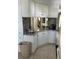 Kitchen features white cabinets, granite countertops, and a breakfast bar at 782 Londra Dr, Venice, FL 34285