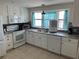 Bright kitchen with white cabinets and granite countertops at 782 Londra Dr, Venice, FL 34285