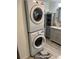Stackable LG washer and dryer in a laundry room with gray cabinets and flooring at 782 Londra Dr, Venice, FL 34285