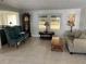 Living room with two armchairs, grandfather clock, and tiled floor at 782 Londra Dr, Venice, FL 34285