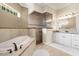 Bathroom with soaking tub, walk-in shower, and double vanity at 793 Vanderbilt Dr, Nokomis, FL 34275