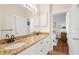 Bathroom featuring a double vanity, granite counters, white cabinets, tile flooring, and ensuite bedroom access at 793 Vanderbilt Dr, Nokomis, FL 34275