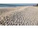 Scenic beach view with white sand and ocean waves at 793 Vanderbilt Dr, Nokomis, FL 34275