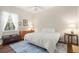 Bright bedroom with a queen-size bed, dresser, and window coverings at 793 Vanderbilt Dr, Nokomis, FL 34275