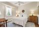 Bright bedroom features a window seat, wood floors, and neutral walls with traditional furnishings at 793 Vanderbilt Dr, Nokomis, FL 34275