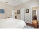 Bright bedroom with wood floors, neutral walls, and an ensuite bathroom is perfect for guests at 793 Vanderbilt Dr, Nokomis, FL 34275