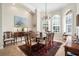 Bright dining room with large windows, chandelier, dining table with chairs, and an elegant rug at 793 Vanderbilt Dr, Nokomis, FL 34275