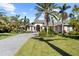 Beautiful home with palm trees, a paved driveway, and a well-manicured lawn at 793 Vanderbilt Dr, Nokomis, FL 34275