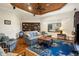 Cozy living room featuring wood ceiling, hardwood floors, built-in shelving, and blue accents at 793 Vanderbilt Dr, Nokomis, FL 34275