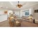 Comfortable living area overlooking a pool, furnished with stylish seating, and offering ample natural light at 793 Vanderbilt Dr, Nokomis, FL 34275