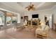 Cozy living room with fireplace and seating, flowing into outdoor patio area at 793 Vanderbilt Dr, Nokomis, FL 34275