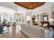 Bright living room featuring a tray ceiling, tile floors, neutral walls, and an open floor plan at 793 Vanderbilt Dr, Nokomis, FL 34275