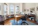 Bright home office with hardwood floors, built-in shelving, and large windows at 793 Vanderbilt Dr, Nokomis, FL 34275