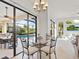 Small breakfast nook with glass table and chairs overlooking pool area at 804 Amaryllis Ln, Venice, FL 34292