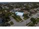 Aerial view of property highlighting blue trim exterior, landscaping, and location close to beach at 842 Nokomis S Ave, Venice, FL 34285