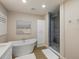 Spa-like bathroom with a walk-in shower and soaking tub at 842 Nokomis S Ave, Venice, FL 34285