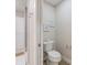 Small bathroom with toilet, shower, and white cabinets at 842 Nokomis S Ave, Venice, FL 34285
