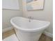 Close-up of a soaking tub with a modern faucet and elegant design at 842 Nokomis S Ave, Venice, FL 34285