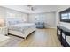 Bright bedroom featuring a plush bed, sitting area, wood-look flooring, and natural light at 842 Nokomis S Ave, Venice, FL 34285