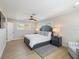 Neutral bedroom with wood floors, and gray accents, including a dark gray bed set and gray rug at 842 Nokomis S Ave, Venice, FL 34285