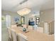 Spacious dining room with a large wooden table and chandelier at 842 Nokomis S Ave, Venice, FL 34285