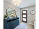 Inviting entryway with stylish console table, mirror, and modern lighting fixture at 842 Nokomis S Ave, Venice, FL 34285