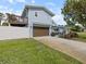 Charming blue house with deck, brown two-car garage door, and well-manicured lawn at 842 Nokomis S Ave, Venice, FL 34285