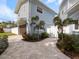 Charming blue home with manicured landscaping and long paver driveway at 842 Nokomis S Ave, Venice, FL 34285