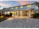 Stunning light blue home with a covered entryway and paved driveway at 842 Nokomis S Ave, Venice, FL 34285