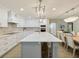 Modern kitchen with white cabinets, herringbone backsplash, and large island at 842 Nokomis S Ave, Venice, FL 34285