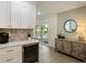 Modern kitchen with white cabinets, herringbone backsplash and wine cooler at 842 Nokomis S Ave, Venice, FL 34285