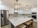 Bright kitchen boasts white cabinetry, a large island with seating, and stainless steel appliances at 842 Nokomis S Ave, Venice, FL 34285
