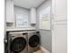 Bright laundry room featuring a new washer and dryer, and ample storage at 842 Nokomis S Ave, Venice, FL 34285