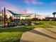 A colorful outdoor playground on a sunny day, with a water tower in the distance at 842 Nokomis S Ave, Venice, FL 34285
