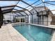 Large screened-in pool with a view of the house at 842 Nokomis S Ave, Venice, FL 34285