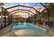Screened pool area with pavers and seating, perfect for relaxing evenings and enjoying the sunset at 842 Nokomis S Ave, Venice, FL 34285