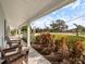 Relaxing front porch with two comfortable chairs overlooking the street at 842 Nokomis S Ave, Venice, FL 34285