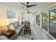 Bright sunroom with sliding doors, comfortable seating, and pool view at 842 Nokomis S Ave, Venice, FL 34285